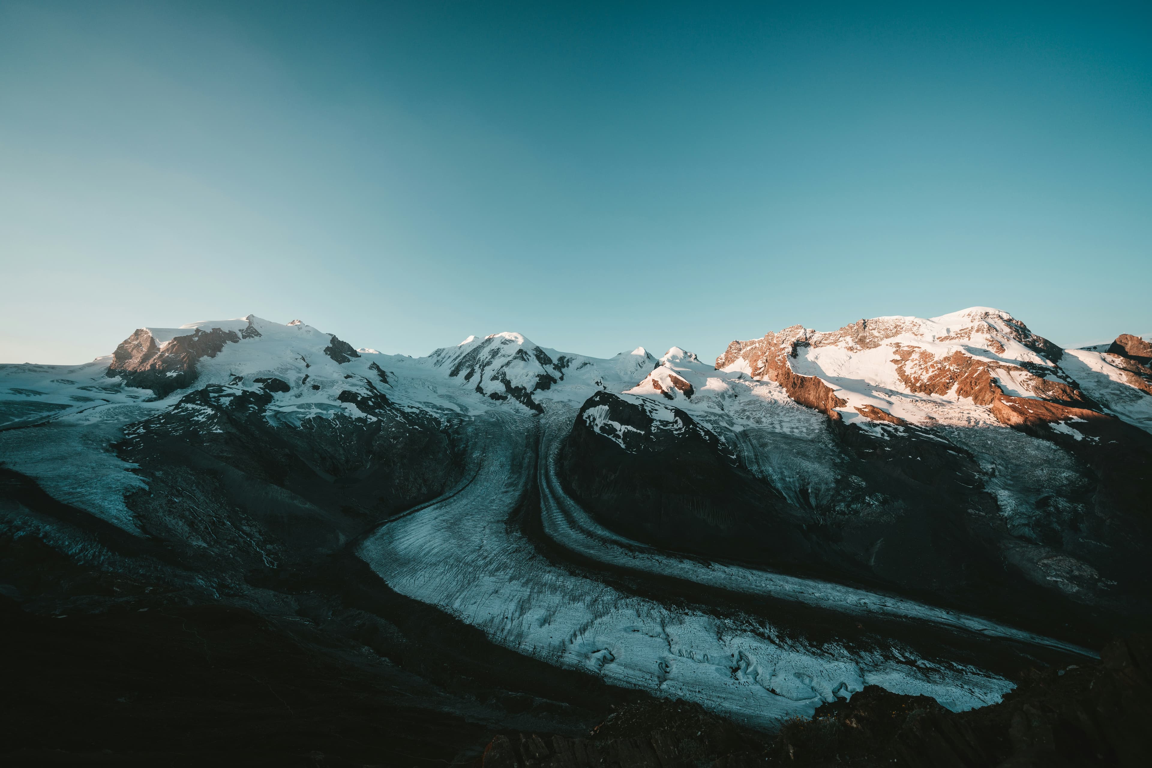 snow covered mountain under blue sky during daytime